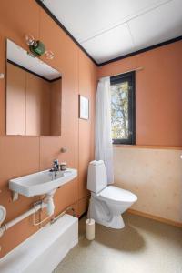 a bathroom with a toilet and a sink at Tomasjord home, the top floor in Trondalen