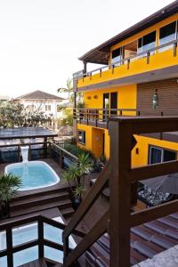 a balcony view of a building with a swimming pool at Pousada Maria Eduarda in Guarda do Embaú