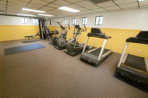 a gym with several treadmills and exercise bikes at Sea Mist Resort in Mashpee