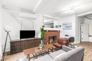 a living room with a couch and a fireplace at Cozy Inn Holbrook NorthEnd in Hamtramck