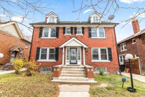 a red brick house with a front door at Cozy Inn Holbrook NorthEnd in Hamtramck