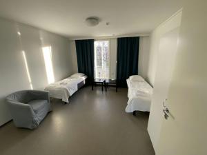 a hospital room with three beds and a chair at Practical Apartment for 2 in Smedsbacka
