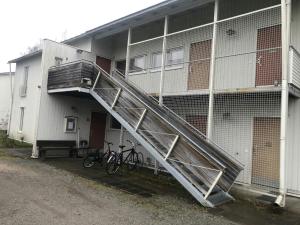 a staircase leading to a building with bikes parked outside at Practical Apartment for 2 in Smedsbacka