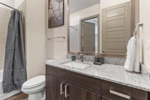 a bathroom with a sink and a toilet and a mirror at Cozy Hideaway, Rooftop Pool, Gym, Shops nearby in Georgetown +18 photos