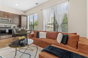 a living room with a couch and a table at Modern Luxe Oasis, Rooftop Pool, Near Austin in Georgetown