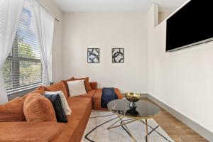 a living room with a couch and a table at Modern Luxe Oasis, Rooftop Pool, Near Austin in Georgetown