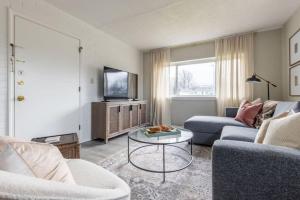 a living room with a couch and a tv and a table at Westlake Getaway Apartment in Westlake