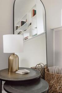 a round table with a lamp on it with a mirror at Westlake Getaway Apartment in Westlake +23 photos