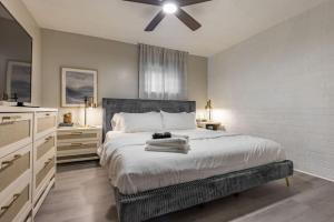 a bedroom with a bed with a ceiling fan at Westlake Getaway Apartment in Westlake
