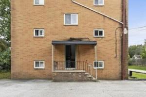 a brick building with a staircase in front of it at Westlake Getaway Apartment in Westlake