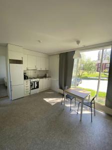 a kitchen with a table and chairs in a room at Practical Apartment for 2 in Smedsbacka