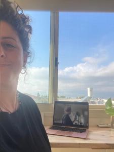 a woman standing in front of a laptop computer at Restart Ramot-ריסטארט צימר ברמות in Moshav Ramot +31 photos