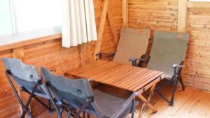 a wooden table and two chairs in a room at Nodaira Campsite - Vacation STAY 43841v in Ichiba