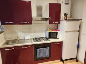 a small kitchen with a stove and a microwave at Your home outlet 4 in Serravalle Scrivia