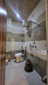 a bathroom with a toilet and a sink at Hotel Maa Aarti Palace in Ujjain +18 photos