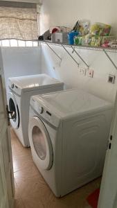a washing machine and a washer in a kitchen at EvP in Kumasi