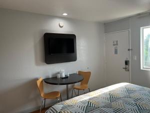 a room with a bed and a table and a tv at Motel 6 Dallas, TX – St. Augustine / HWY 175 in Dallas