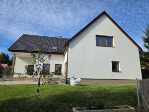 a white house with a black roof at Chalupa Svratouch36 in Svratouch
