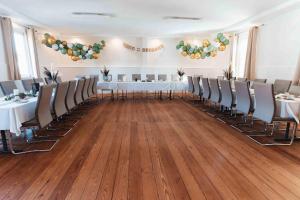 a banquet hall with white tables and chairs and balloons at Pension zur Linde in Kleinwallstadt