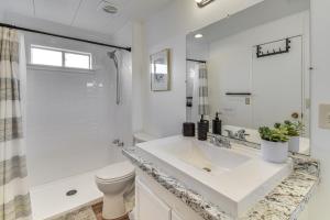 a white bathroom with a sink and a toilet at Mtn-View Coulter Escape w/ Rustic Tree Lookout in Coulterville +16 photos