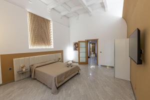 una camera da letto con un letto e una TV a schermo piatto di Fiera & Luna appartament a Catania