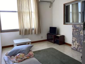 a living room with a bed and a tv at Ichigoso - Vacation STAY 19648 in Ichihara +18 photos