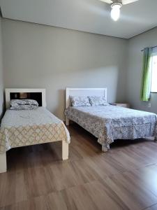 Кровать или кровати в номере Pousada Pérola Mineira