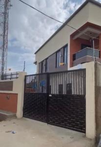 a house with a black iron fence at Luxury 1BR apartment with free wifi in Lagos