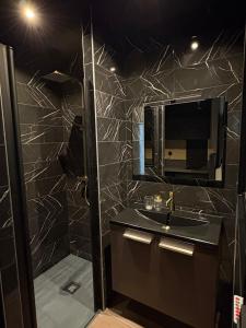 a bathroom with a sink and a mirror at La Romantique in Bressuire