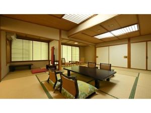 a large room with a table and chairs at Osakaya Ryokan - Vacation STAY 37090v in Kusatsu