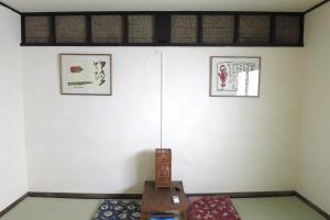 a room with a table and two pictures on the wall at Oyado Dokumasu - Vacation STAY 33206v in Furano +10 photos