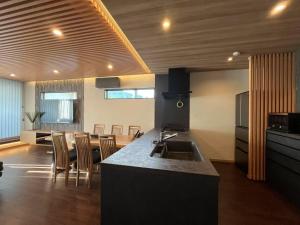 a kitchen with a kitchen island with a counter top at Umenoyu Bettei - Vacation STAY 41988v in Dazaifu
