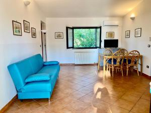 a living room with a blue couch and a table at Villa Marina Grande in San Sostene Marina