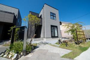 a large white house with at Ume no Yu Moonlight - Vacation STAY 42183v in Dazaifu