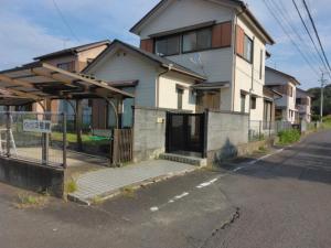 a house with a bus stop in front of it at Townhouse No, 3 - Vacation STAY 43084v in Sanuki
