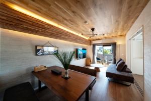 a living room with a table and a couch at Sound Crest Gojo Station - Vacation STAY 45803v in Dazaifu