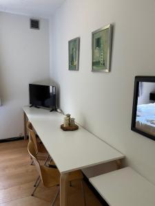 a white desk with a computer and two chairs at Egtved Hotel in Egtved +4 photos