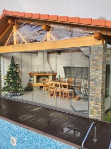 a house with a large glass wall with a table and chairs at Lauterhofen Haus 8 in Lauterhofen
