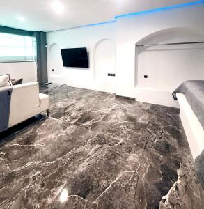 a living room with a large marble floor at Cycladic Suite in Thessaloniki