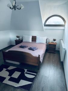 a bedroom with a bed with a window and a rug at Casa Hardic in Horodnic de Sus