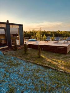 a house with a deck with two benches on it at Casa Hardic in Horodnic de Sus +17 photos