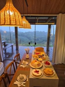 ランショ・ケイマードにあるTiny House em Taquaras, Rancho Queimadoの食べ物の皿が置かれたテーブル +16枚の写真