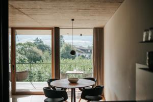 a dining room with a table and chairs and a large window at Langstrein Hof in Laces