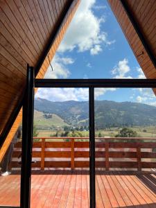 a view from the balcony of a house at Cozy A-Frame Cabins in Bucovina in Şarul Dornei