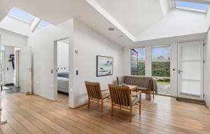 a living room with a table and chairs at 4 Bedroom Lovely Home In Hadsund in Øster Hurup