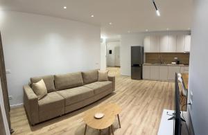 a living room with a couch and a kitchen at Amea Apartments in Durrës