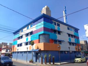 a building with a colorful facade on a street at Hotel Puerto Angel in Ciudad Nezahualcóyotl