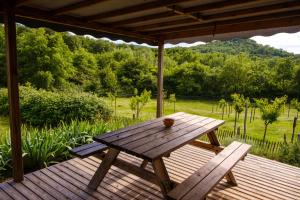 a wooden picnic table sitting on a wooden deck at CA Home in Aiguèze