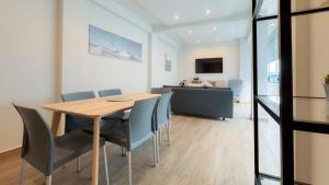 a dining room and living room with a table and chairs at ZIELO Modern apt steps to Zocalo Rooftop view in Mexico City