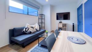 a living room with a table and a couch at ZIELO Modern apt steps to Zocalo Rooftop view in Mexico City